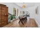 Elegant dining room with a wooden table, stylish chandelier, and hardwood floors at 69 W Cedar Ave, Denver, CO 80223