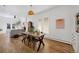 Open concept dining room with natural light, hardwood floors, and views of the living area at 69 W Cedar Ave, Denver, CO 80223