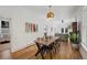 Open concept dining room with a view of the living area, hardwood floors, and natural light at 69 W Cedar Ave, Denver, CO 80223