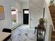 Bright entryway with marble floors, a black front door, and a large window letting in natural light at 69 W Cedar Ave, Denver, CO 80223