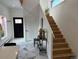 Bright foyer with marble floors, pink window trim and stairs with contemporary decor, creating a welcoming and stylish entrance at 69 W Cedar Ave, Denver, CO 80223