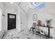 Foyer with modern decor and a black entry door featuring marble floors at 69 W Cedar Ave, Denver, CO 80223