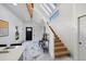 Foyer with natural light, modern staircase, and marble tile floors at 69 W Cedar Ave, Denver, CO 80223