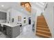 Open-concept foyer and kitchen area with stairs, wood accents and marble flooring at 69 W Cedar Ave, Denver, CO 80223