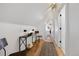 Bright hallway featuring natural wood floors, with decorative lighting and stylish accents, and an inviting space at 69 W Cedar Ave, Denver, CO 80223