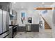 Modern kitchen with stainless steel appliances, large sink, and marble floors at 69 W Cedar Ave, Denver, CO 80223