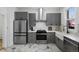 Kitchen with modern appliances, gray cabinets, farmhouse sink, and marble floors at 69 W Cedar Ave, Denver, CO 80223