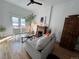 Cozy living room featuring a fireplace, comfortable seating, and a stylish ceiling fan, creating a relaxing and inviting atmosphere at 69 W Cedar Ave, Denver, CO 80223