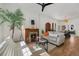 Bright living room with hardwood floors, fireplace, and access to the dining area at 69 W Cedar Ave, Denver, CO 80223