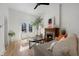 Bright living room with hardwood floors, fireplace, and access to an outdoor seating area at 69 W Cedar Ave, Denver, CO 80223