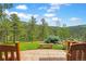 Picturesque backyard features a stone bench, lush trees, and views, perfect for relaxation and enjoying the natural surroundings at 2398 Bitterroot Ln, Golden, CO 80401