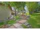 Landscaped backyard featuring a stone staircase and lush greenery at 2398 Bitterroot Ln, Golden, CO 80401