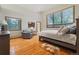 Spacious bedroom with hardwood floors, large windows offering views, and comfortable seating area at 2398 Bitterroot Ln, Golden, CO 80401