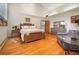 Bright bedroom featuring hardwood floors, high ceilings, large windows, and neutral decor at 2398 Bitterroot Ln, Golden, CO 80401