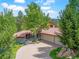 Charming home with a tile roof, a spacious driveway, and mature trees, offering curb appeal and ample parking space at 2398 Bitterroot Ln, Golden, CO 80401