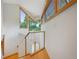Bright hallway with hardwood floors, glass railing, and multiple windows, offering a modern and airy feel at 2398 Bitterroot Ln, Golden, CO 80401