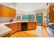 Spacious kitchen with wood cabinets, countertops, and natural light, complete with modern appliances at 2398 Bitterroot Ln, Golden, CO 80401