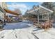 Spacious backyard with pergola, deck, and snow-covered ground at 8478 Prairie Clover Way, Parker, CO 80134