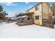 House's backyard features a deck and snowy landscape at 8478 Prairie Clover Way, Parker, CO 80134