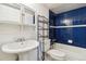 Bathroom with blue tile, white pedestal sink, and tub at 8478 Prairie Clover Way, Parker, CO 80134