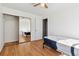 Bright bedroom with mirrored closet and wood flooring at 8478 Prairie Clover Way, Parker, CO 80134