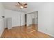 Bedroom with wood flooring, ceiling fan, and mirrored closet at 8478 Prairie Clover Way, Parker, CO 80134