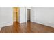 Bedroom with wood flooring and mirrored closet doors at 8478 Prairie Clover Way, Parker, CO 80134