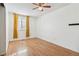 Bedroom with wood flooring, ceiling fan, and yellow curtains at 8478 Prairie Clover Way, Parker, CO 80134