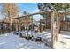 Wooden chicken coop in a fenced snowy backyard at 8478 Prairie Clover Way, Parker, CO 80134