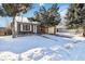 Brick ranch home with attached garage and snowy yard at 8478 Prairie Clover Way, Parker, CO 80134