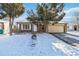 Ranch style home with a snow-covered yard and attached garage at 8478 Prairie Clover Way, Parker, CO 80134