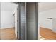 Hallway with gray shiplap walls and wood flooring at 8478 Prairie Clover Way, Parker, CO 80134