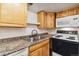 Kitchen with wood cabinets and granite countertop at 8478 Prairie Clover Way, Parker, CO 80134