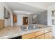 Kitchen features a double sink and light wood cabinets at 8478 Prairie Clover Way, Parker, CO 80134