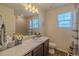 Well-lit bathroom featuring a marble countertop, a shower, and updated fixtures at 12 S Oak Hill Way, Aurora, CO 80018