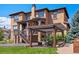 Backyard boasts a covered patio, a pergola, and manicured lawn at 2256 S Isabell Ct, Lakewood, CO 80228