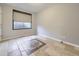 Neutral tile-floored basement with a covered window and grey painted walls at 2256 S Isabell Ct, Lakewood, CO 80228