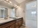 Bathroom boasts double sink vanity, dark wood cabinets, and overhead lighting at 2256 S Isabell Ct, Lakewood, CO 80228