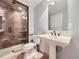 Bathroom features a glass enclosed tile shower and pedestal sink at 2256 S Isabell Ct, Lakewood, CO 80228