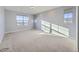 The bedroom is sun-filled and spacious, with large windows and neutral carpet flooring at 2256 S Isabell Ct, Lakewood, CO 80228