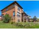 A well-maintained exterior with stone accents, outdoor living space, and lush greenery at 2256 S Isabell Ct, Lakewood, CO 80228
