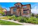 Beautiful home with stone accents, a tiled roof, manicured landscaping, and an inviting front entrance at 2256 S Isabell Ct, Lakewood, CO 80228