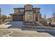 Beautiful two-story home showcasing a well-manicured lawn, stone accents, and a driveway at 2256 S Isabell Ct, Lakewood, CO 80228
