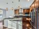 Well-lit kitchen with stainless steel appliances, an oversized kitchen island, and pendant lighting at 2256 S Isabell Ct, Lakewood, CO 80228