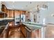 Modern kitchen with stainless steel appliances, an oversized kitchen island, and hardwood floors at 2256 S Isabell Ct, Lakewood, CO 80228