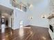 Spacious living room with hardwood floors, a fireplace, and a grand chandelier creates an elegant ambiance at 2256 S Isabell Ct, Lakewood, CO 80228