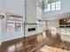 Bright living room featuring a stone fireplace, hardwood floors, and a soaring ceiling with a chandelier at 2256 S Isabell Ct, Lakewood, CO 80228