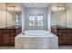 Luxurious primary bathroom with a soaking tub, dual vanities, and a serene ambiance for relaxation at 2256 S Isabell Ct, Lakewood, CO 80228