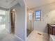 Bright bathroom with a glass-enclosed shower, a sink vanity, and easy access to the bedroom at 2256 S Isabell Ct, Lakewood, CO 80228