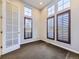 Bright office space with plantation shutters, carpeted floor, and a glass door for natural light at 2256 S Isabell Ct, Lakewood, CO 80228